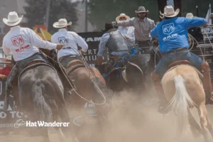 A group of cowboy performing in a rodeo event