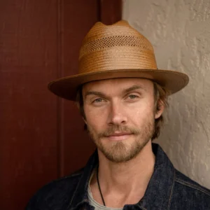 A boy wearing Open Road Vented Straw Cowboy Hat